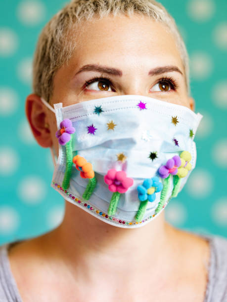 istock Young woman with artsy face mask 1242033382