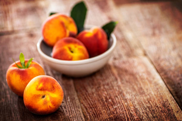istock Peaches on Retro wood Picnic Bench 1242033906