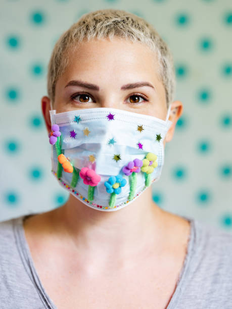 istock Young woman with artsy face mask 1242037717
