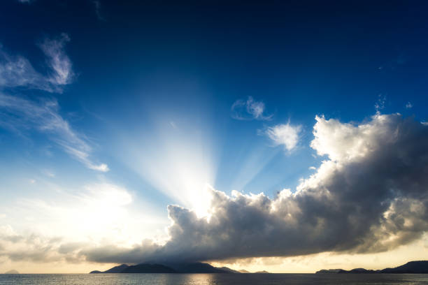 The sun breaks through the clouds at dawn