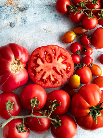 Fresh tomato salad with onion and basil on white table background. Concept for a tasty and healthy meal