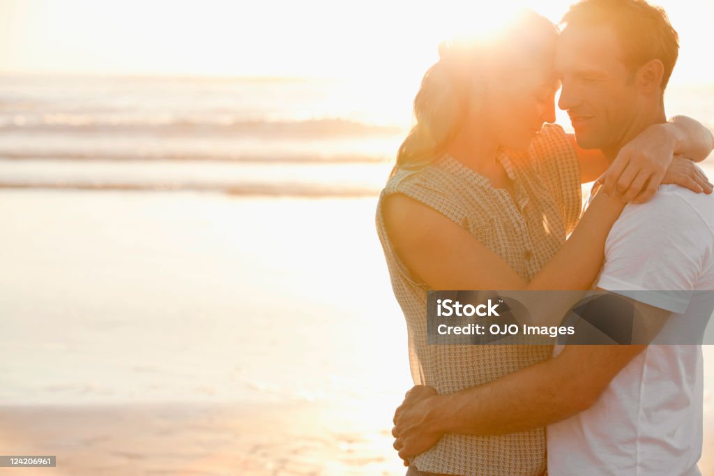 Romantic mid adult couple on a beach  30-39 Years Stock Photo