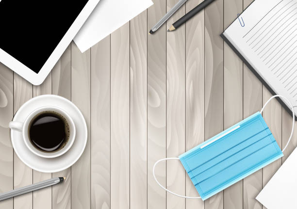 istock COVID-19 prevention concept on wooden office table desk. Tablet, Office Supplies and Face Medical Mask. Vector illustration. 1242070394