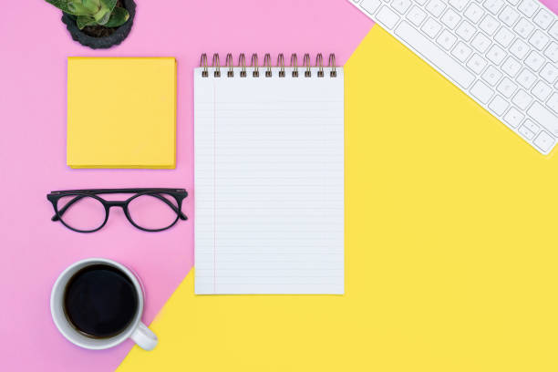 istock pink and yellow working place layout. note pad. writing. coffee, keyboard, glasses. spring concept. copy space flat lay 1242075778