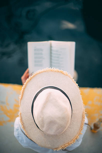 Cute Woman Reading a Book at Seaside