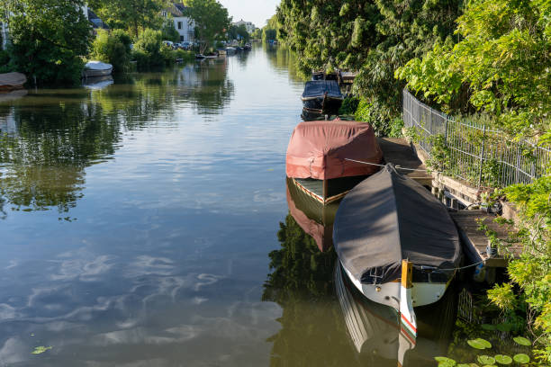 istock Small pleasure boats floating in a river 1242088370