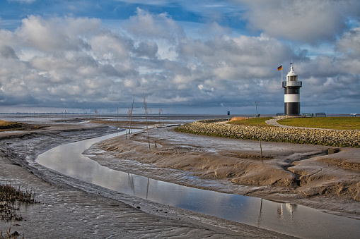 lighthouse and water way at low tide