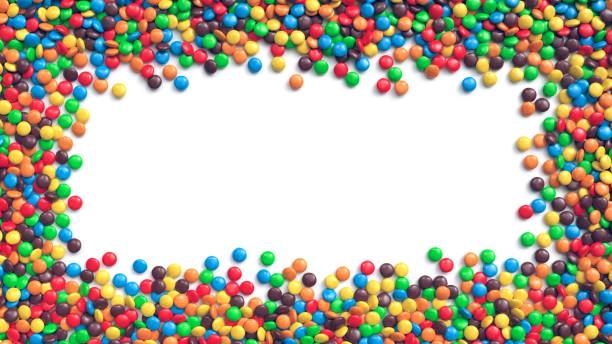istock Colorful coated chocolate candies arranged in frame on white background 1242093549