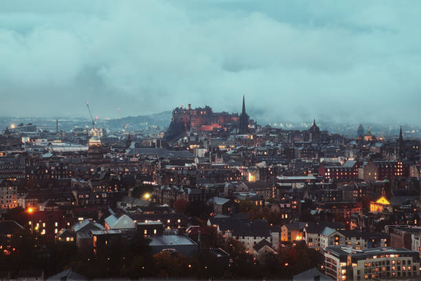 Top view of Edinburgh covered clouds and the Castle in the evening, Edinburgh, Scotland, United Kingdom