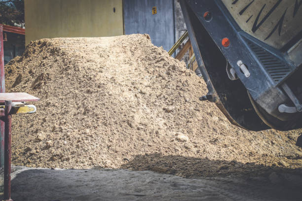 Heap of sand unloaded by dump truck stock photo