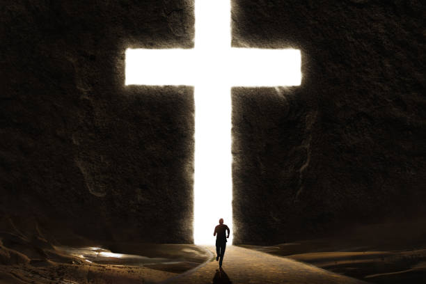 istock Man Running Towards Giant Bright Cross 1242106429