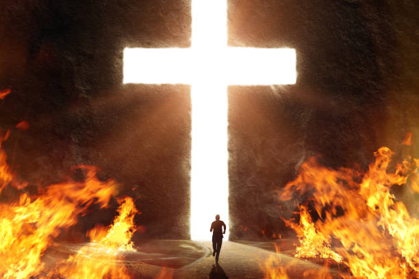 istock Man Running from Flames into Giant Bright Cross 1242106430