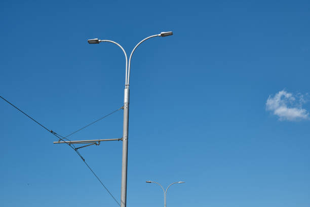 Under the blue sky, street lights and cables details