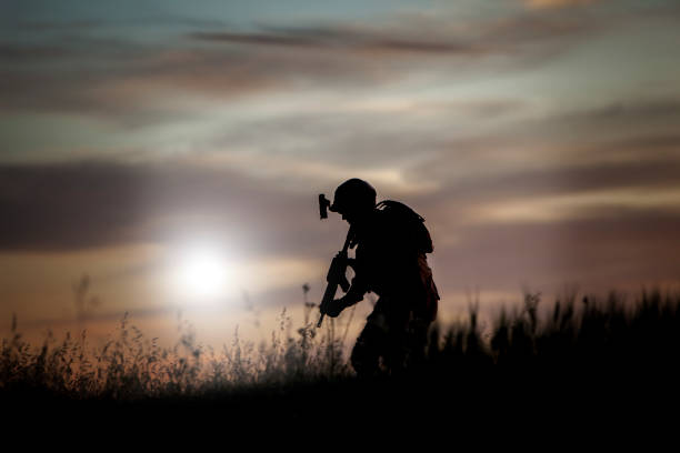 istock silhouette of soldier walking at sunset 1242120032
