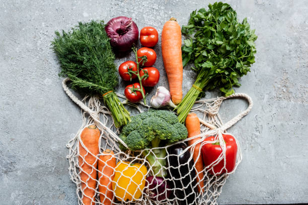 istock top view of fresh ripe vegetables in string bag on grey concrete surface 1242121689
