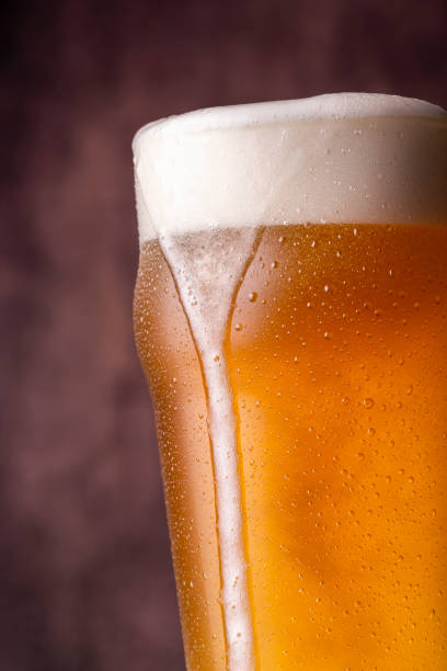Pint of cold pale beer Detail of pint of cold pale beer with froth leaking over the glass fermenting photos stock pictures, royalty-free photos & images
