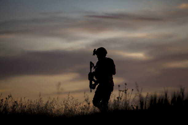 silhouette of soldier running at sunset