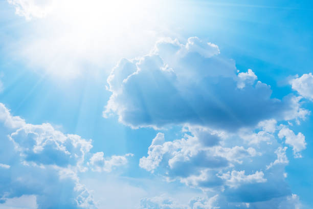 istock Blue sky with white clouds and sun. Nature background 1242127120