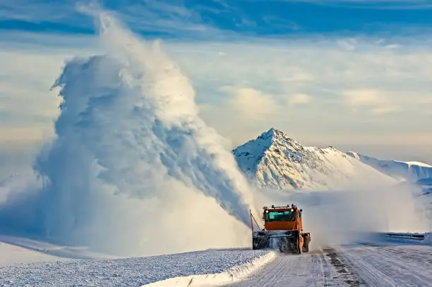 Snow blower, Snow Plow on the Haines Hignway, Yukon, Canada, orange machine, snow blowing