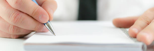 istock Wide view of businessman ready to take notes on an empty note pad 1242129567