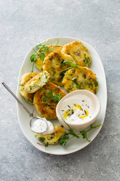 istock Cottage cheese pancakes with spinach on white plate close up 1242133454