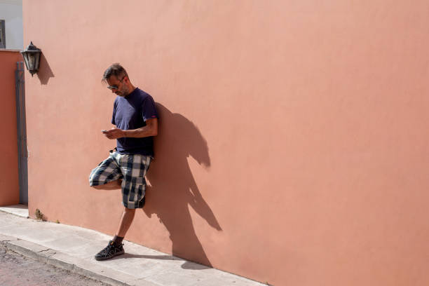istock handsome Man Using his Mobile Phone on a sunny day 1242137168