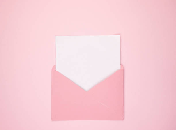istock An open pink envelope containing a blank sheet of white paper, space for text. Space for text on a pink background 1242153628