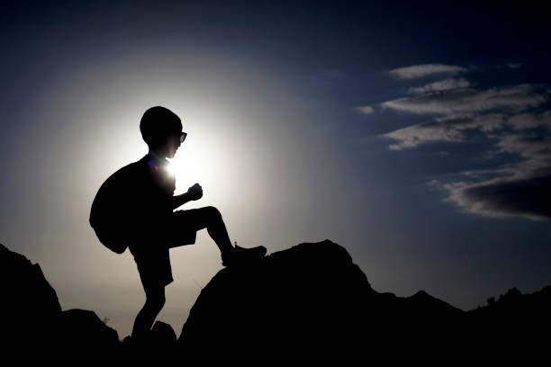 istock silhouette of boy against the sky 1242160601