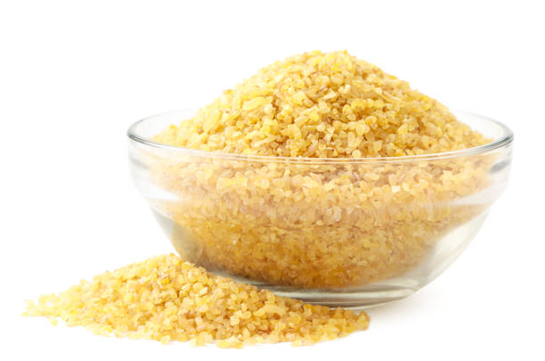istock Dry bulgur in a glass plate close-up on a white background. Isolated 1242167049