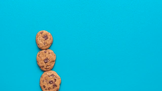 Chocolate chips cookies and milk, top view stop motion