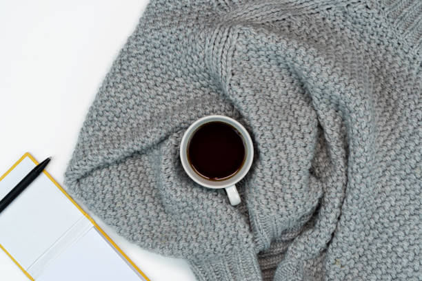 istock Cosy working writing place, sweater coffee and writing accesories. work from home. Warm concept in cold weather. 1242180461