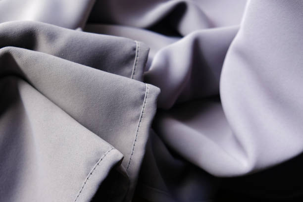 istock Rumpled creased wrinkled material. Soft violet grey silk fabric 1242184307