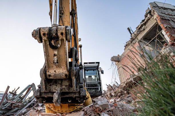 istock Excavator destroing ruins and olfd building. Wide angle closeup shot. 1242184830