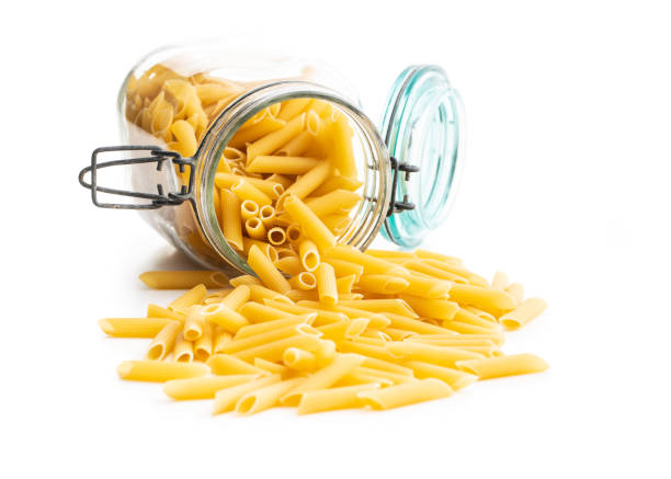 istock Uncooked penne pasta. Dried italian pasta in jar 1242190706