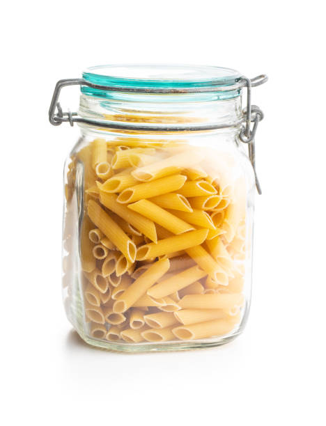 istock Uncooked penne pasta. Dried italian pasta in jar 1242191796