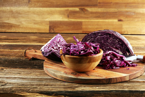 istock Chopped fresh red cabbage. Prepare sliced vegetable for cooking purple cabbage salad or coleslaw. Homemade food concept. 1242192337