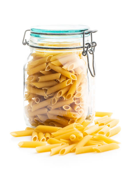 istock Uncooked penne pasta. Dried italian pasta in jar 1242192848