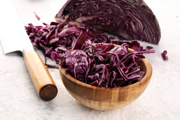 istock Chopped fresh red cabbage. Prepare sliced vegetable for cooking purple cabbage salad or coleslaw. Homemade food concept. 1242193966