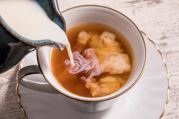 istock Milk being poured into a cup of hot tea 1242194321