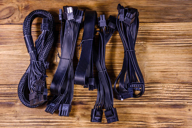 istock Set of computer psu cables on a wooden background 1242206882