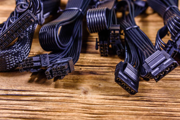 istock Set of computer psu cables on a wooden background 1242206887