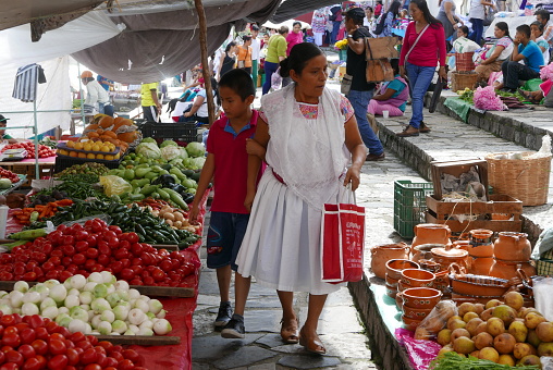Cuetzalan, Puebla, Mexico - August 20, 2017: People walking around to get products at a local market on the streets of Cuetzalan, Puebla.