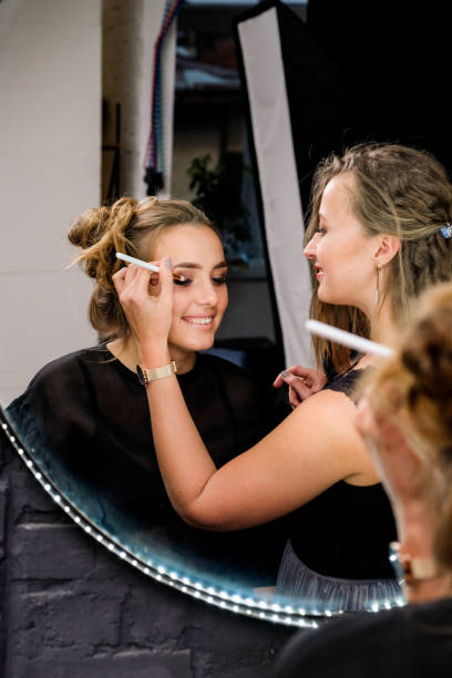 istock Process of applying makeup. Make-up artist working with brush on model face. 1242217339