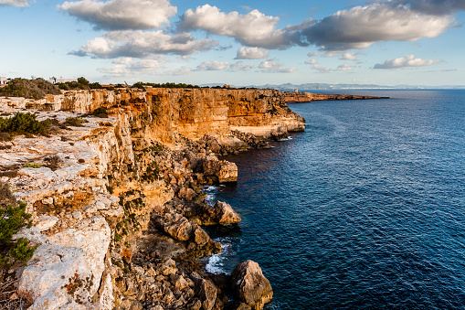 Cliffs of the island of Formentera at dawn. Views of the sea and Ibiza.