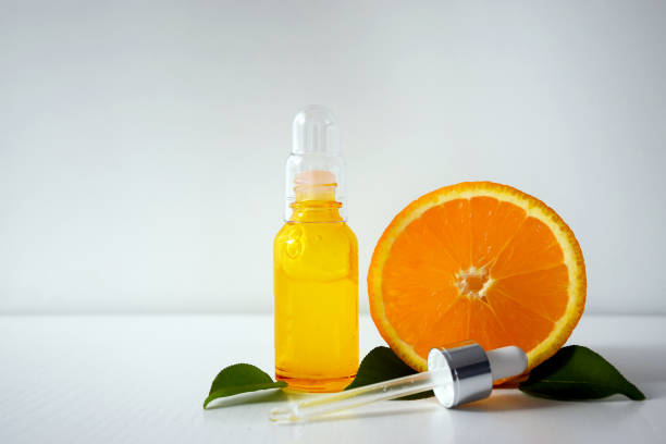 istock Vitamin C serum with dropper and orange 1242264598