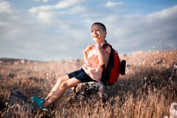 istock cute boy sitting in nature 1242265119