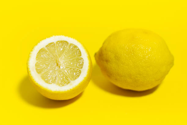 istock Studio picture, close-up of lemon on yellow background. 1242274144