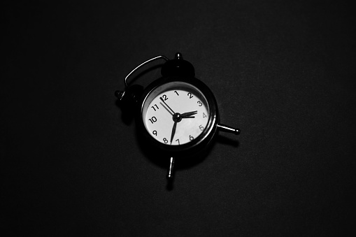 Top view of clock on black background.