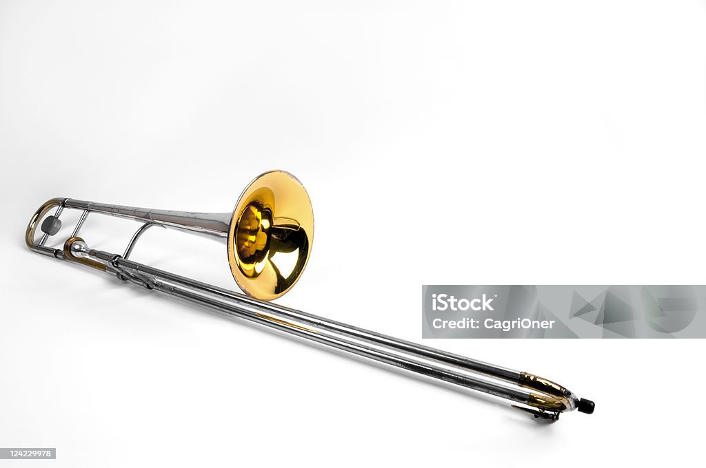 Trombone Old and used trombone on white background. Trombone Stock Photo