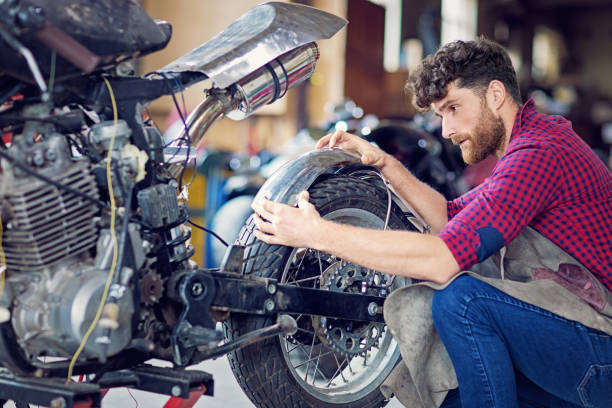 istock Man is working on a custom made motorbike 1242355764